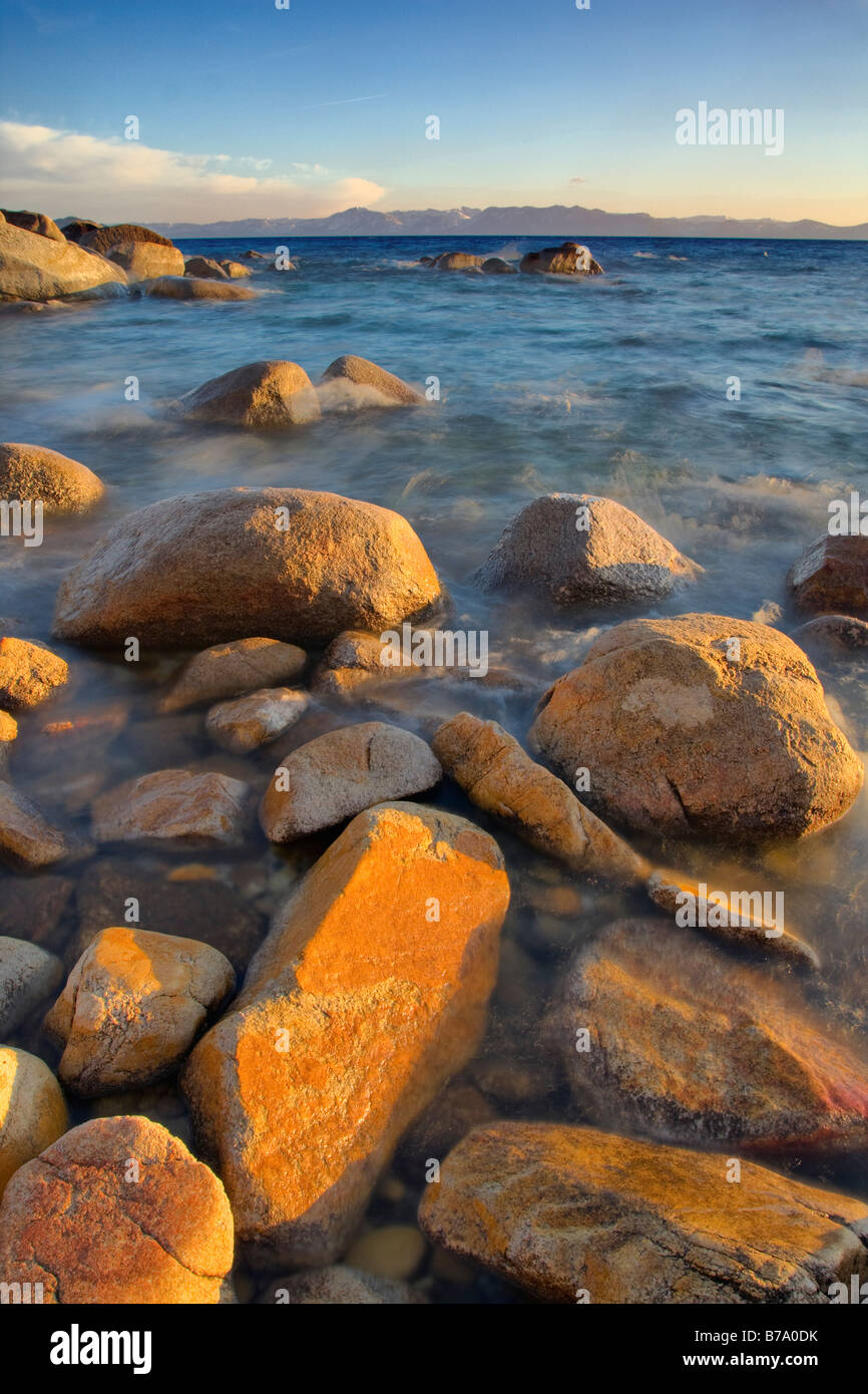 HDR tonemapped Rocks and moving water at sunset on the east shore of Lake Tahoe in Nevada Stock Photo
