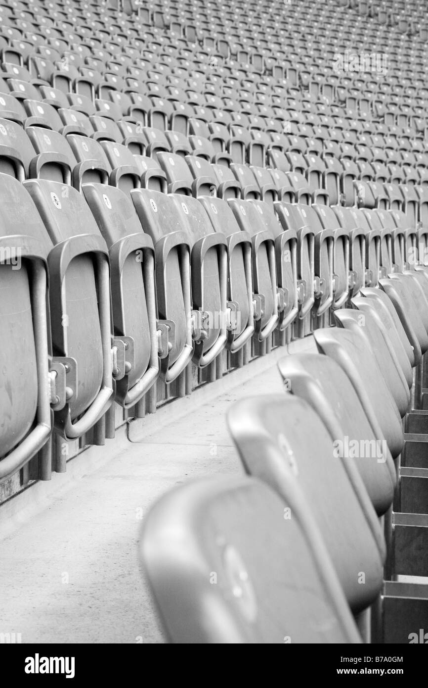 Perspective view of rows of greay empty stadium seats Stock Photo