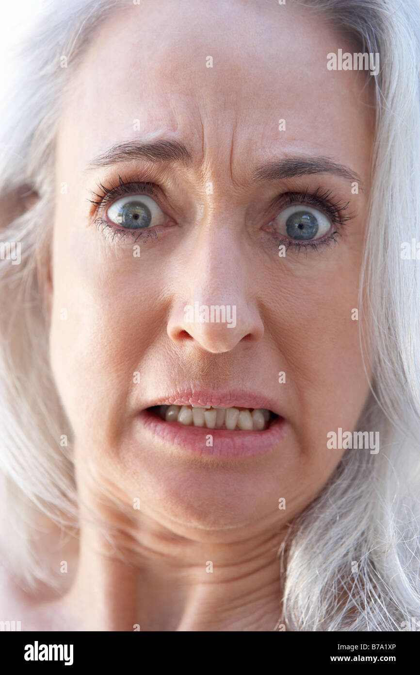 Portrait Of Senior Woman Looking Shocked Stock Photo