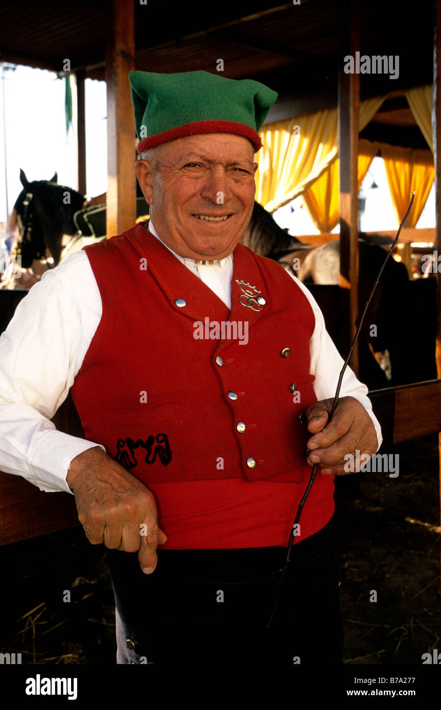A Portuguese campino - a herdsman dressed in traditional attire - outside a stable at the Golegã horse festival in Portugal Stock Photo