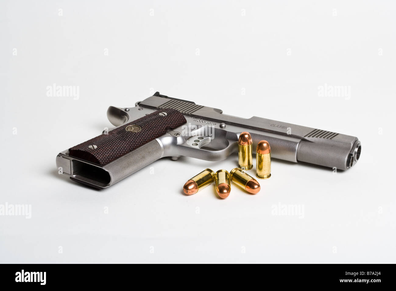 A .45 Auto 1911 style pistol and ammunition Stock Photo