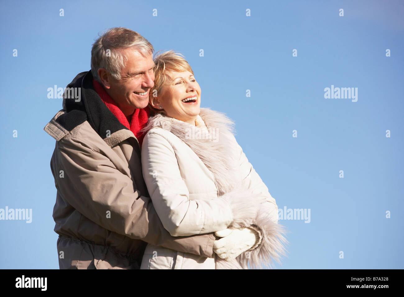 Senior Couple Embracing In Park Stock Photo