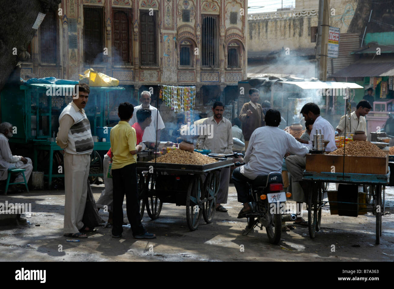 Street scene, men standing around smokey food stands, Lachmangarh, Rajasthan, India, Asia Stock Photo