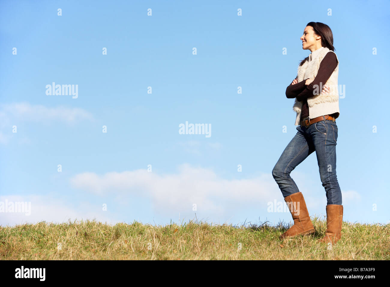 Young Woman Standing In Park Stock Photo