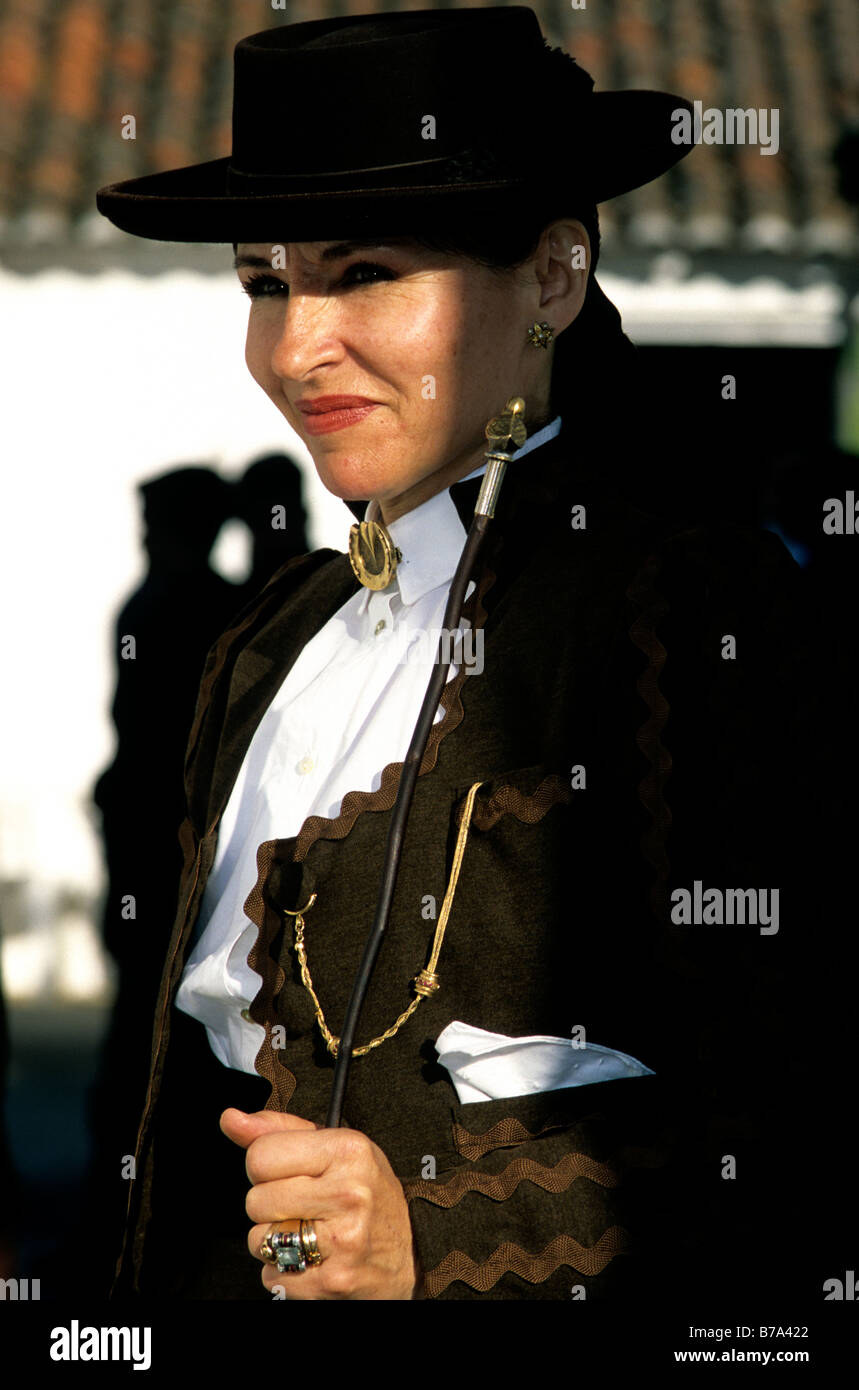 A woman in dressed in decorative equestrian attire at the annual Golegã horse festival in Portugal Stock Photo