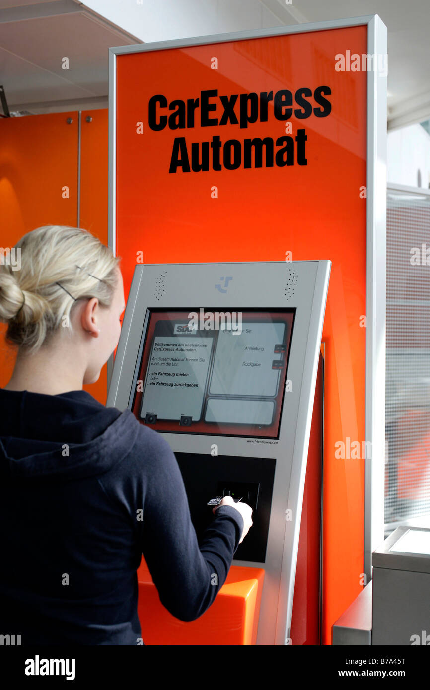 Woman using Car Express self service terminal of the Sixt AG car rental