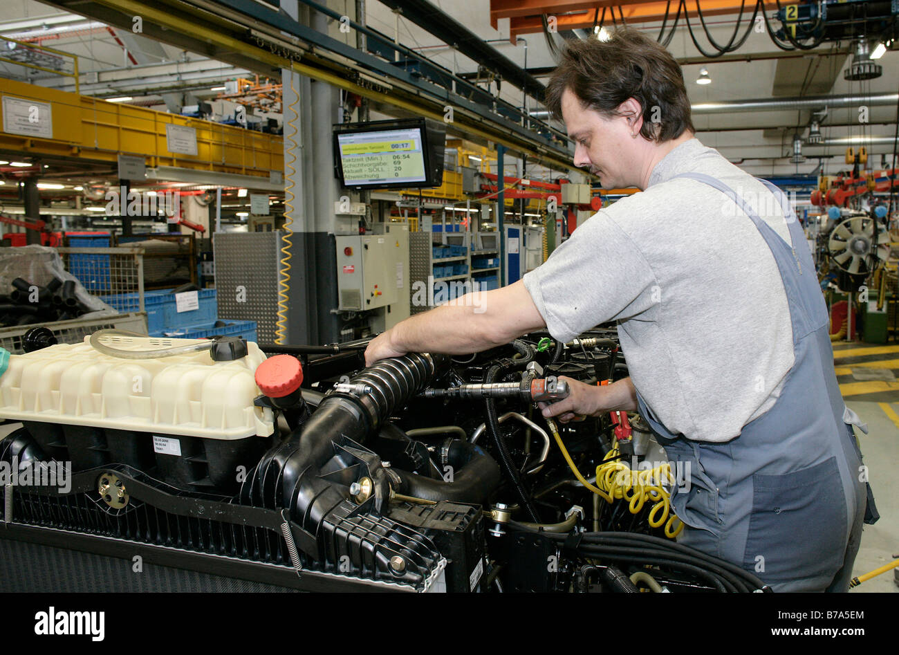 Laborers working on the motor and gearbox of a truck, manufacture, Production MAN Commercial Vehicle Corporation, Munich, Bavar Stock Photo