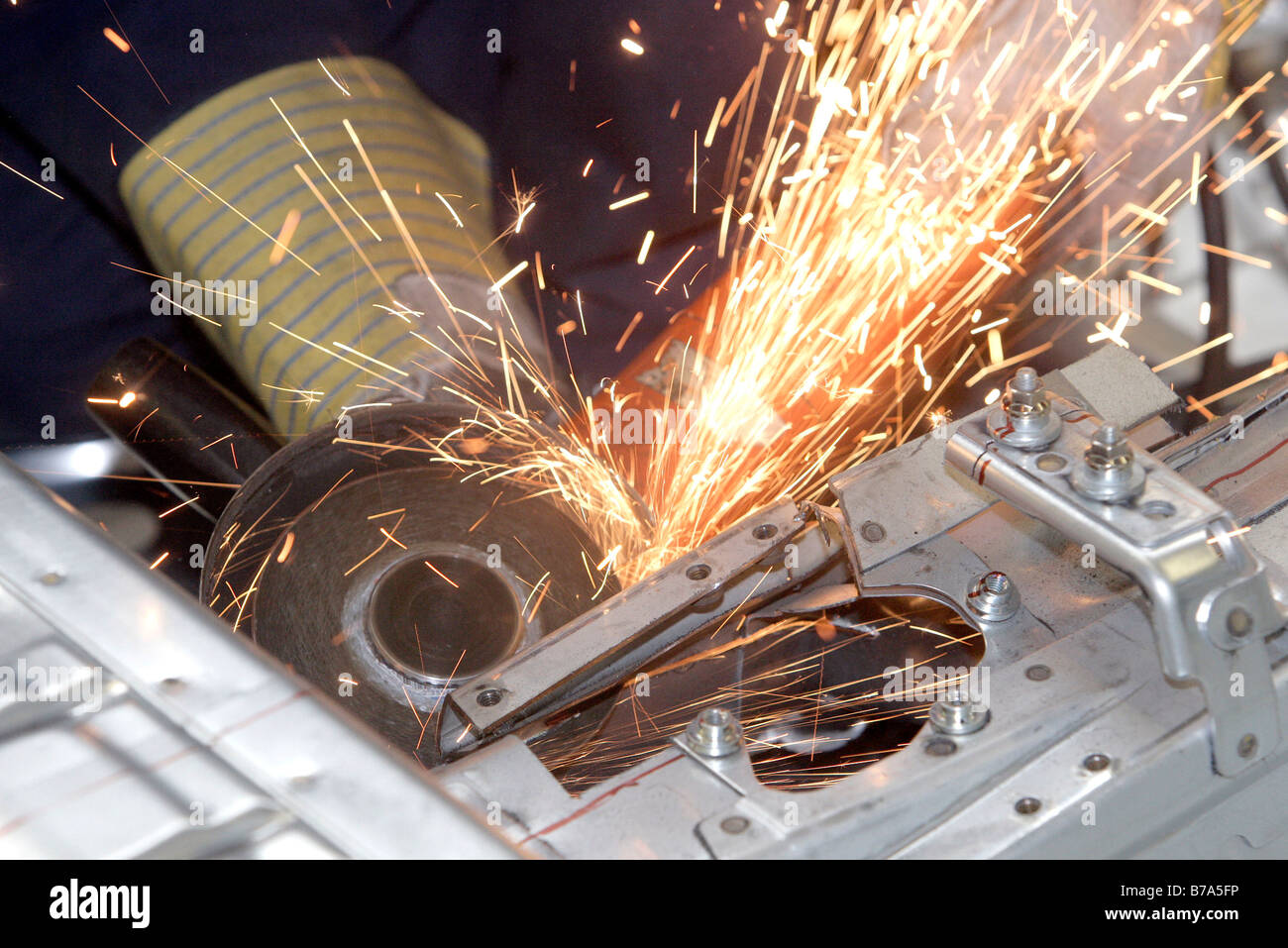 Separation work with an angle grinder on the body of a BMW 3 at a training center, apprenticeship workshop BMW corporation, Reg Stock Photo