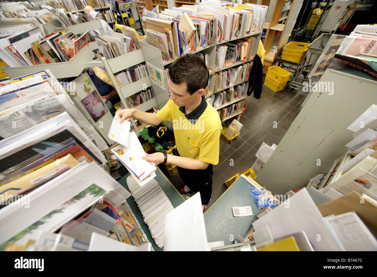 Employee, mailman, of the Deutsche Post AG, German post, sorting his mail in the Regensburg delivery post, Bavaria, Germany, Eu Stock Photo