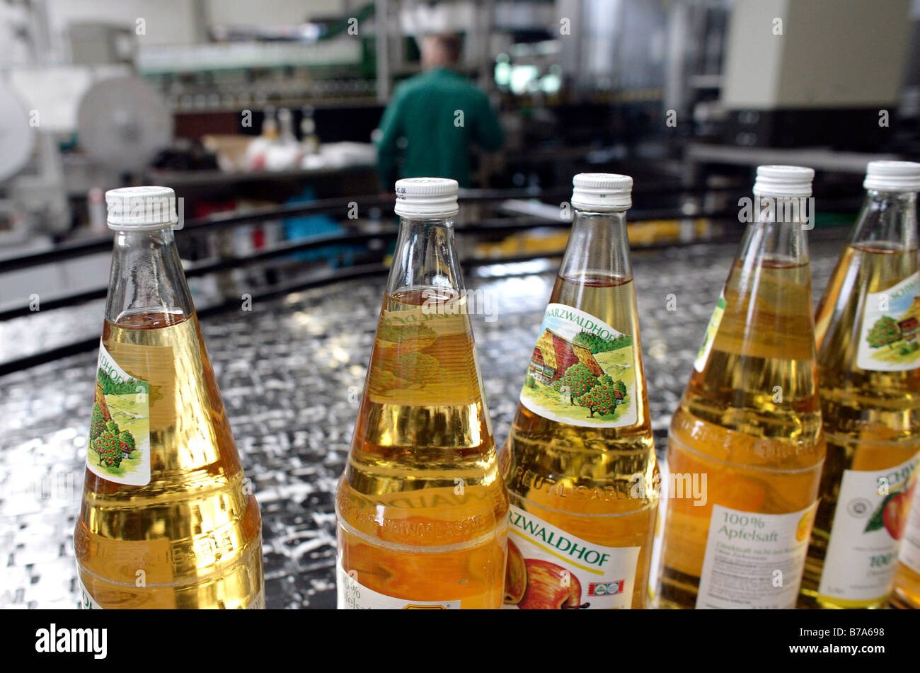 Bottles of apple juice in the bottling plant of fruit juice press Stock