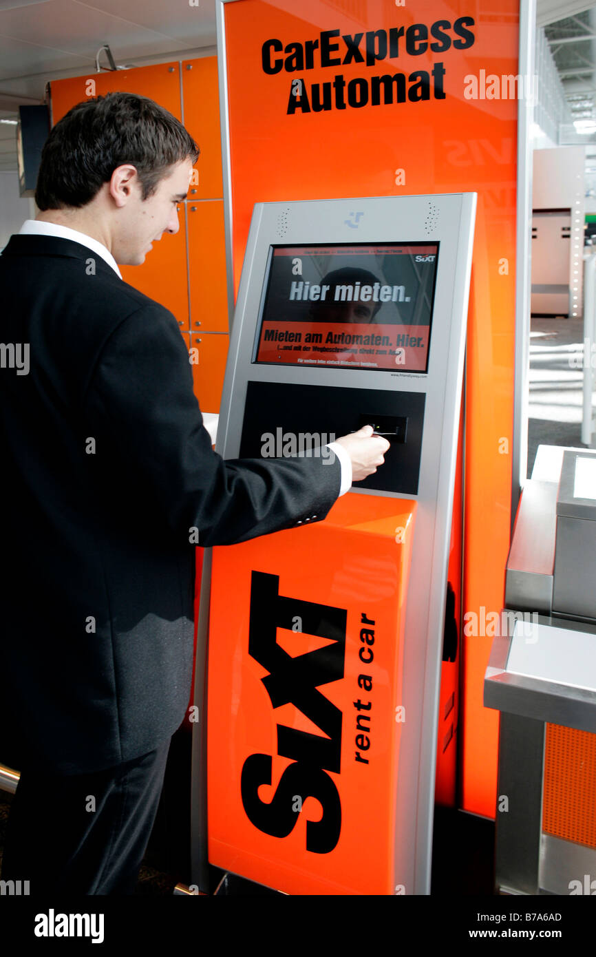 Man using Car Express self service terminal of the Sixt AG car rental company in the Munich Airports, Bavaria, Germany, Europe Stock Photo