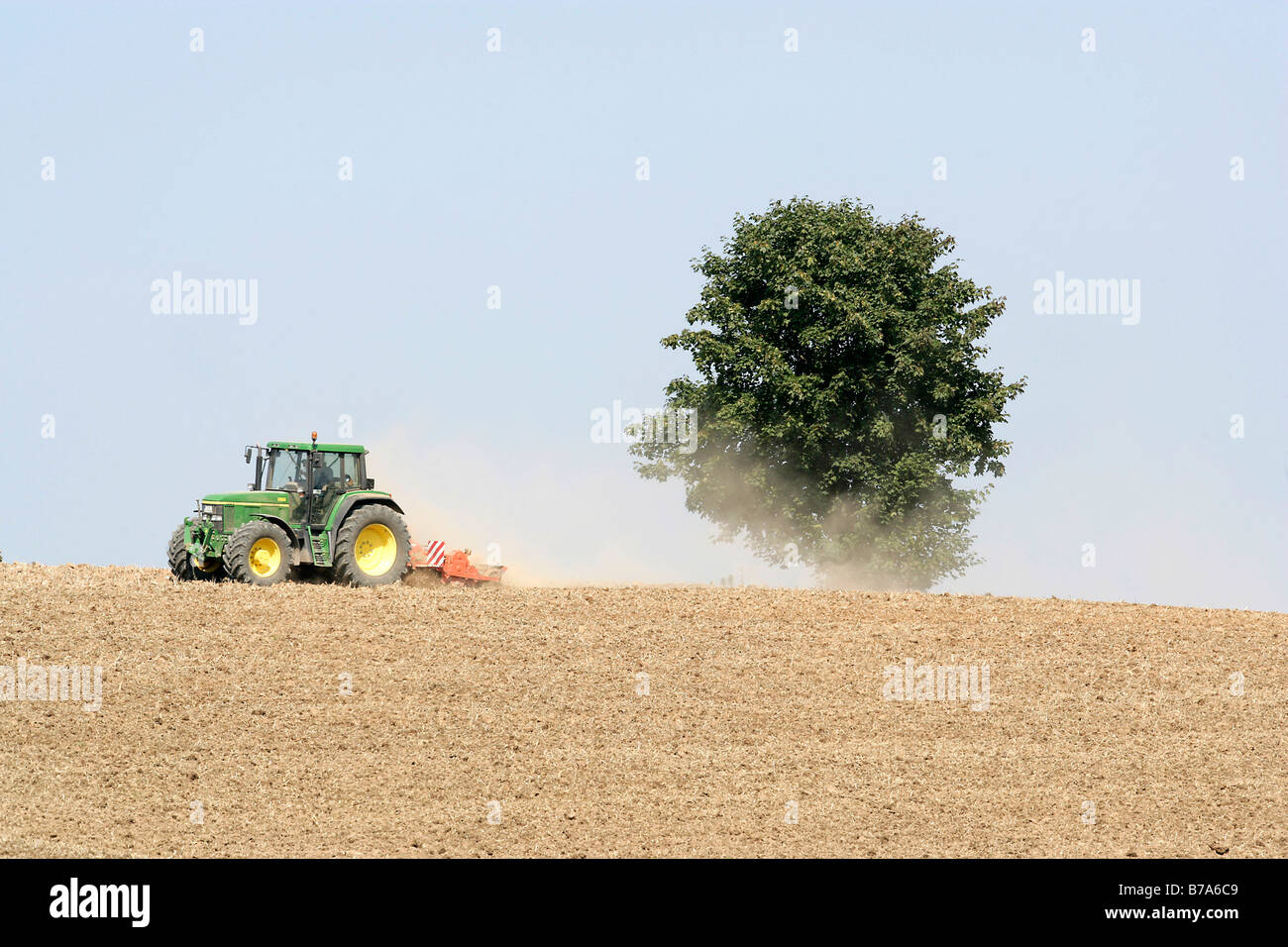 Agriculturist in a tractor ploughing a field near Regensburg, Bavaria, Germany, Europe Stock Photo