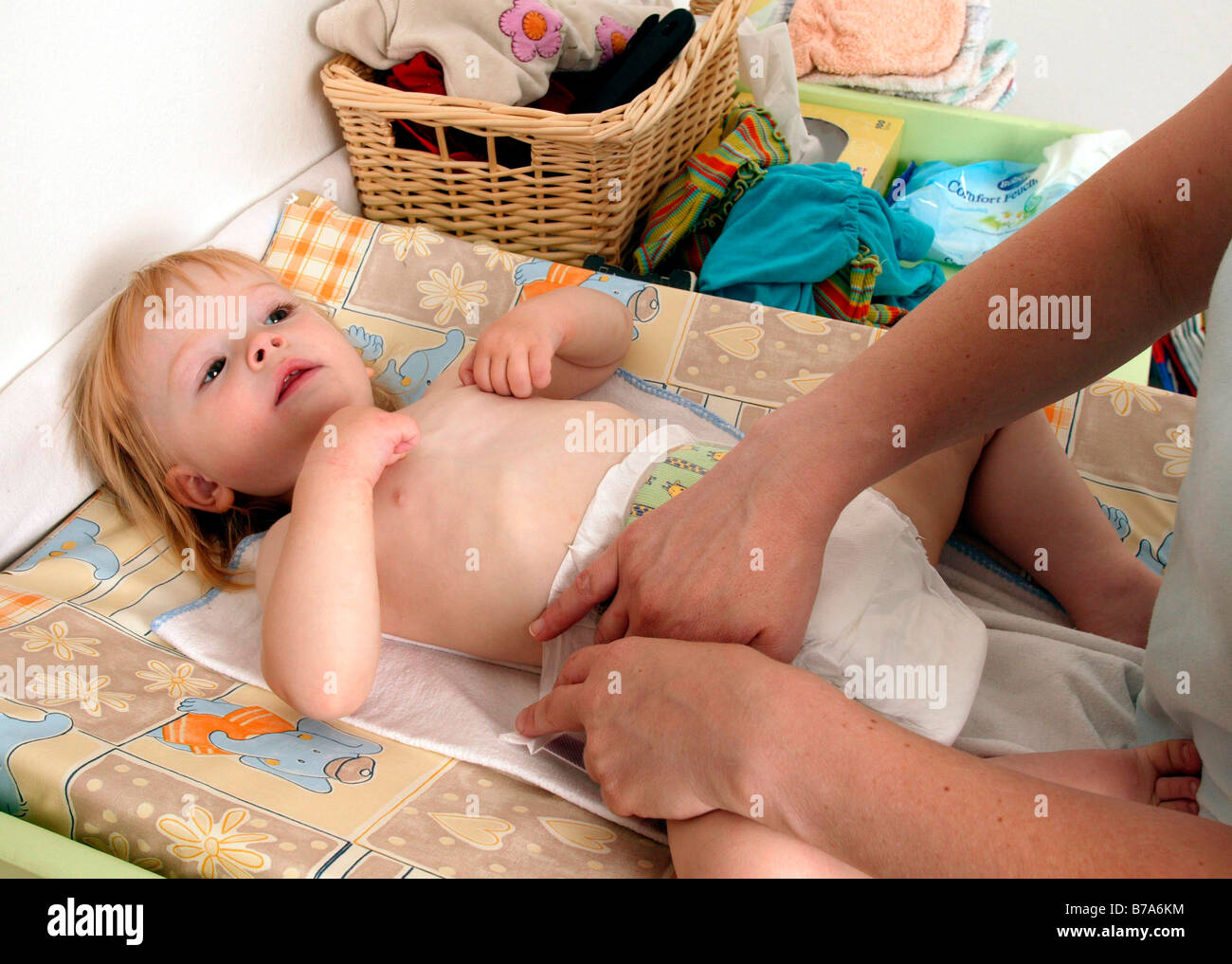 Mother changing a baby's nappy Stock Photo