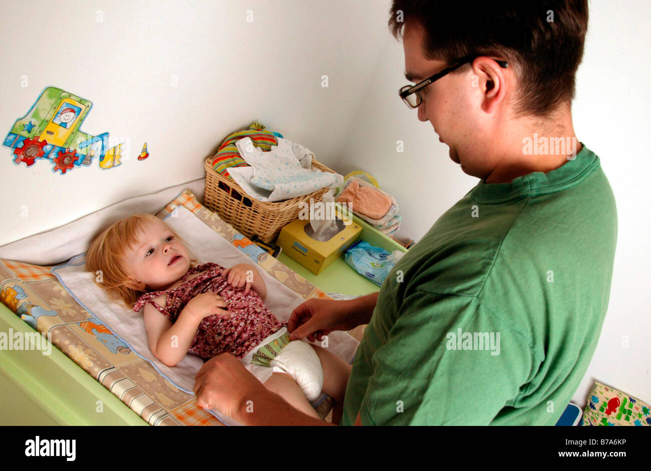 Father changing a baby's nappy Stock Photo