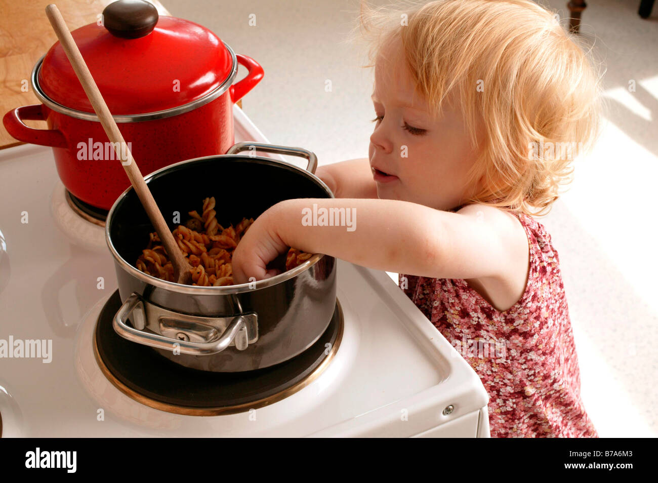 Toddler at the stove Stock Photo