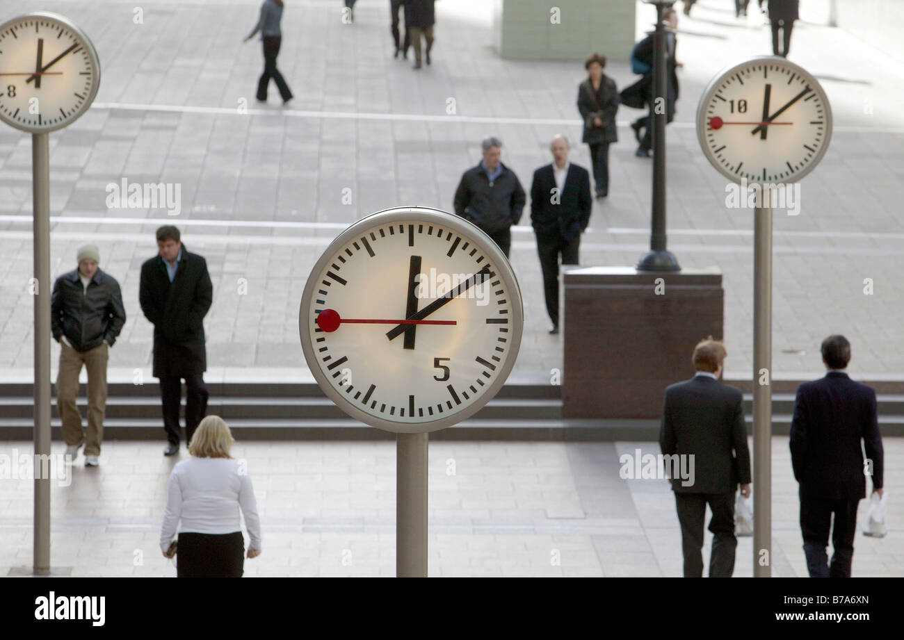Public place with clocks in Canary Wharf in London, England, Great Britain, Europe Stock Photo