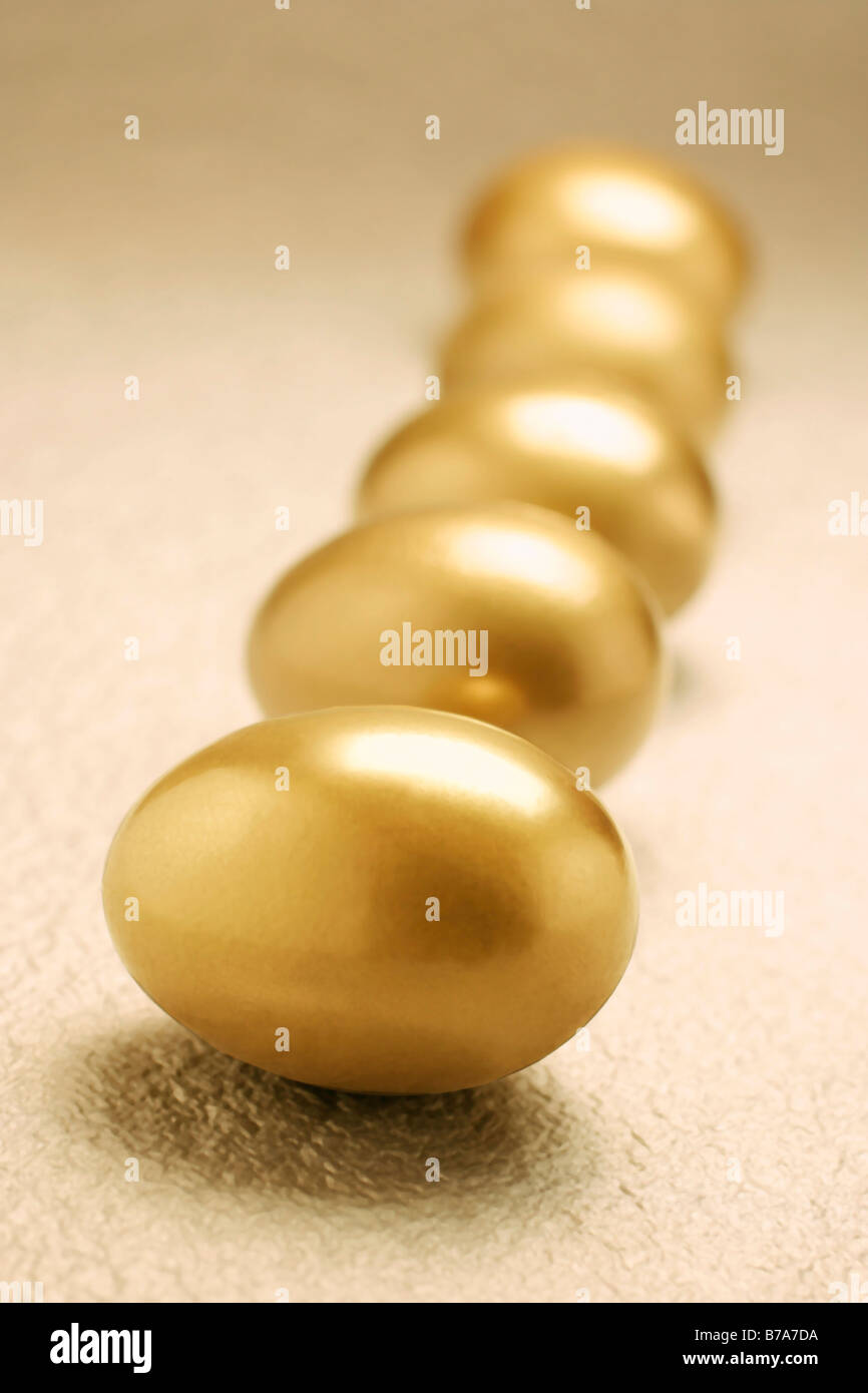 Row of golden eggs Stock Photo