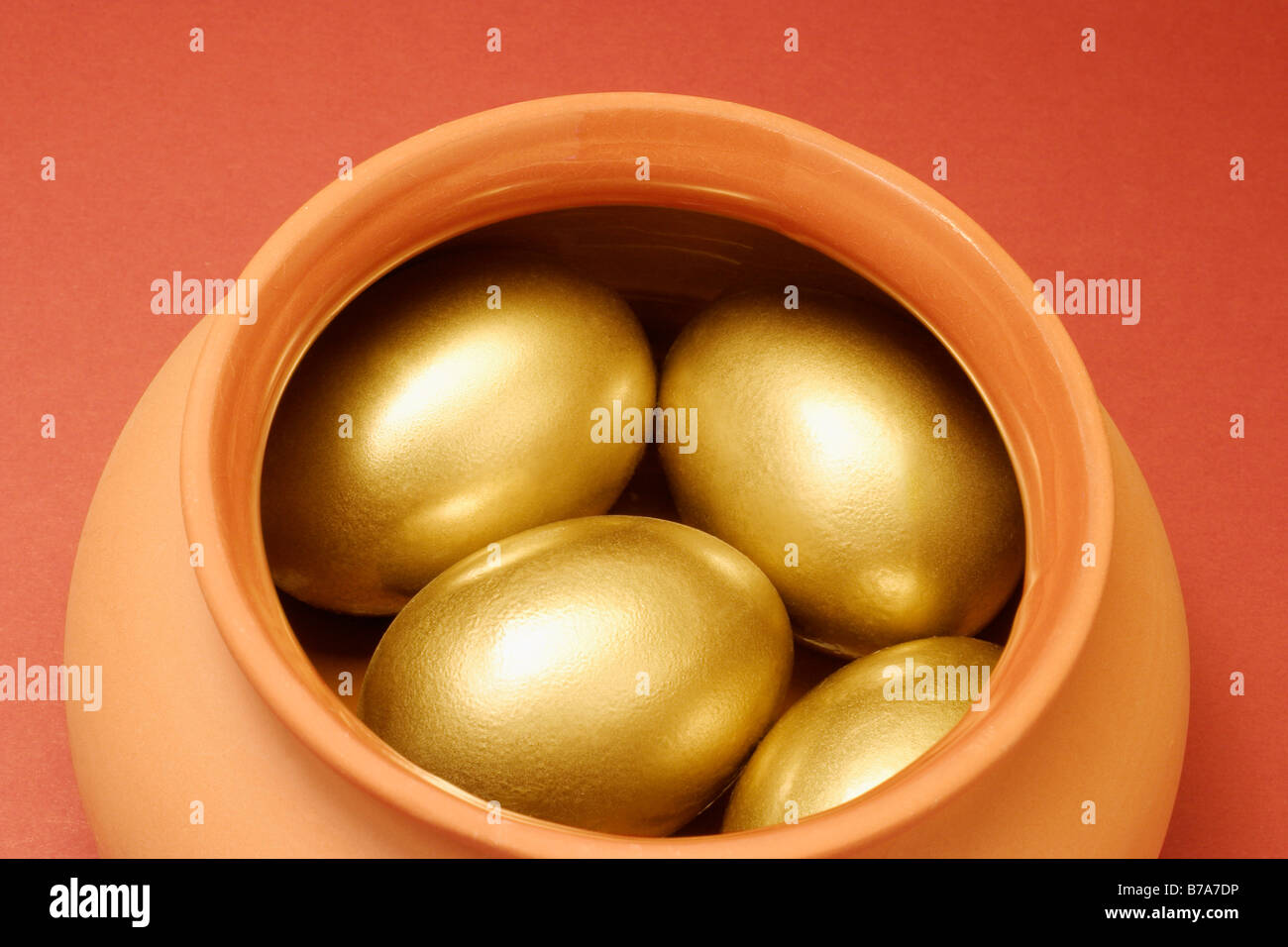 Golden eggs in clay pot Stock Photo Alamy