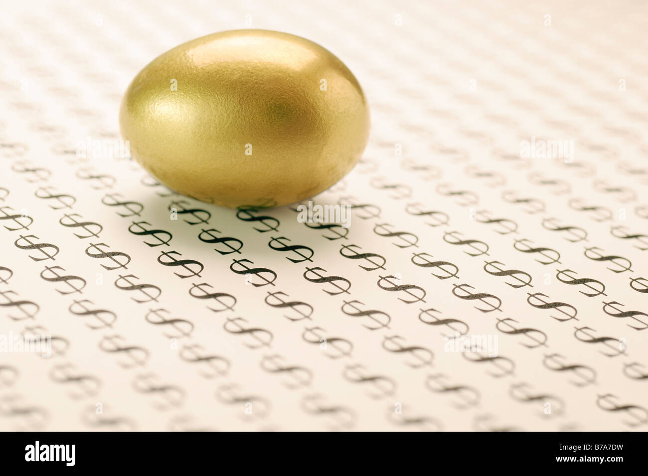 Golden egg and dollar signs Stock Photo