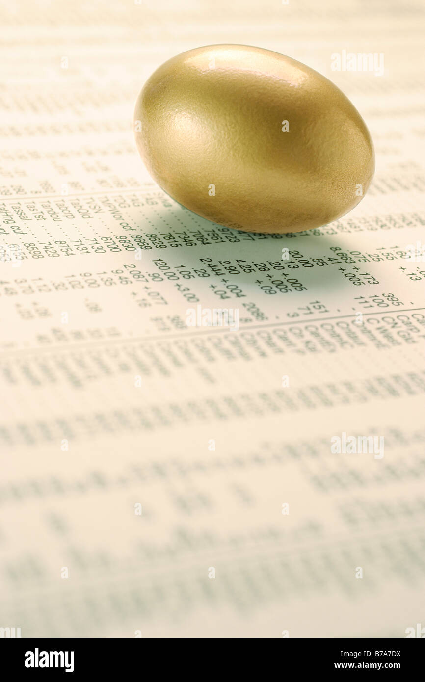 Golden egg on stock listings Stock Photo