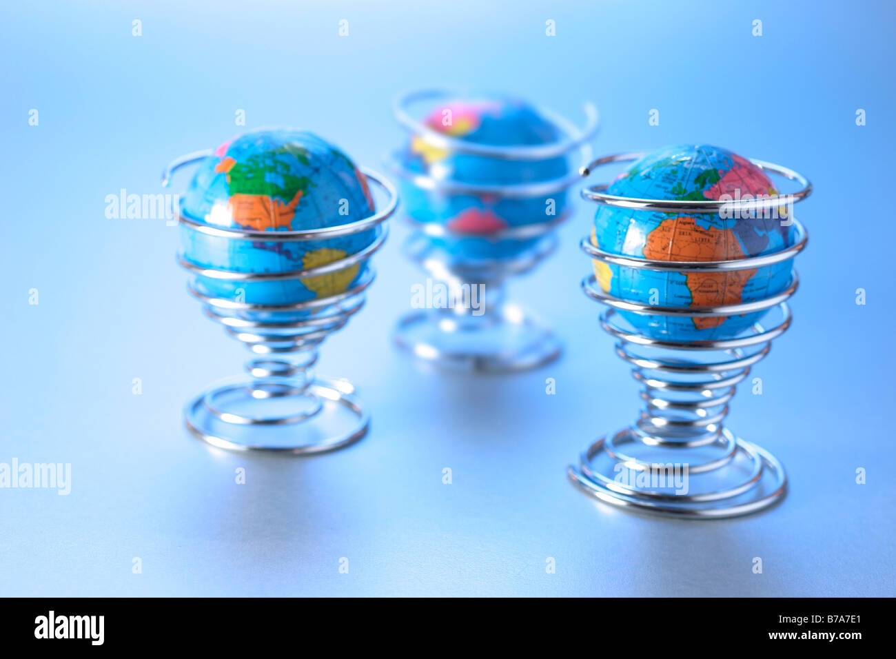 Miniature globes in egg cups Stock Photo