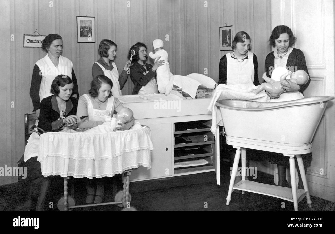 Historic photo, women learning how to deal with newborn babies, ca. 1920 Stock Photo