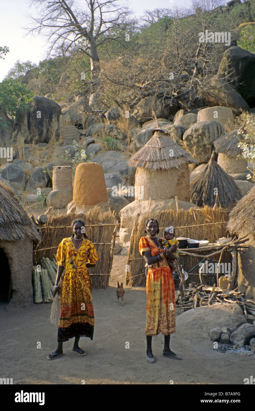 Two Nubian woman standing in their village, one holding a baby. Stock Photo