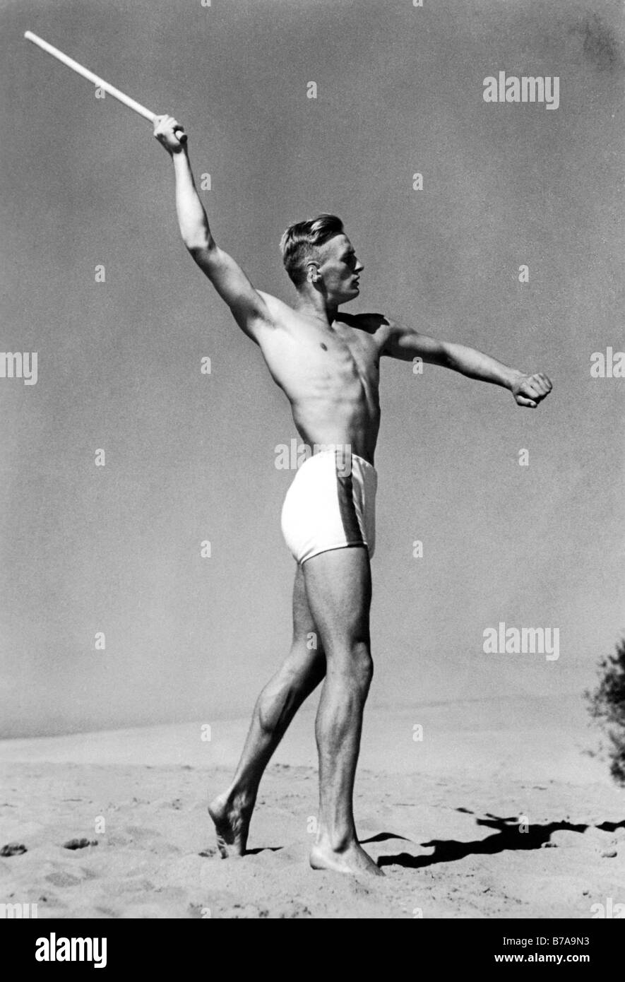 Historic photo, man throwing stick, ca. 1940 Stock Photo