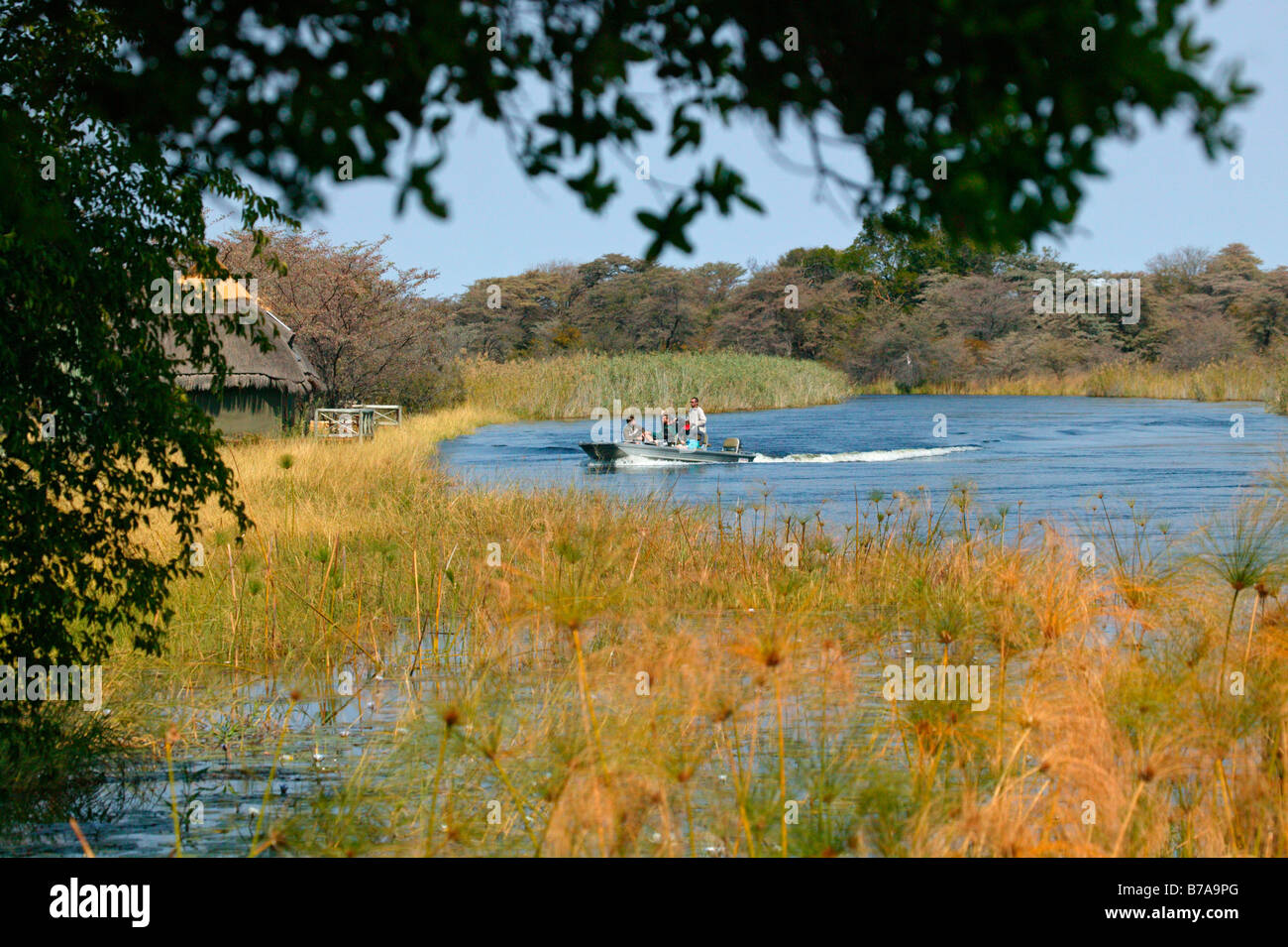 Tourists arrive at Camp Kwando after a boat ride on the Kwando River Stock Photo