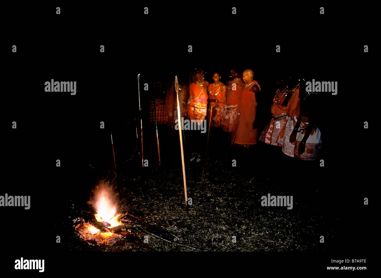 Maasai Moran dancing near an open fire at night Stock Photo