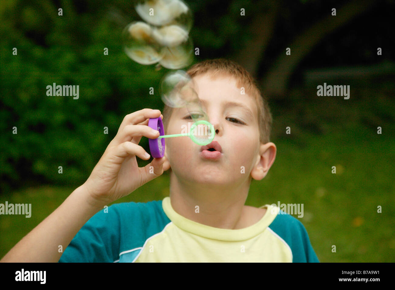 A Young Child Blowing Bubbles Model Released Stock Photo Alamy