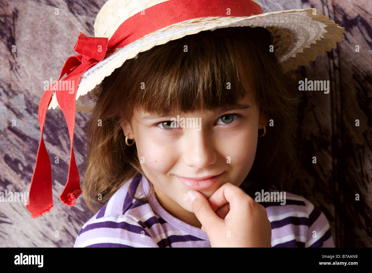 Girl wearing a hat with red ribbon Stock Photo