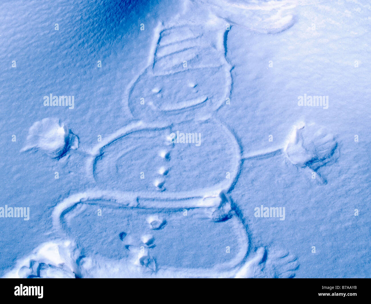 Snowman marked out in the snow Stock Photo