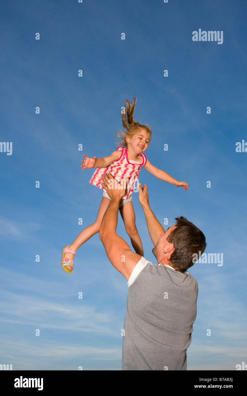 Father, 29 years old playing outdoors with his 3 year old daughter Stock Photo
