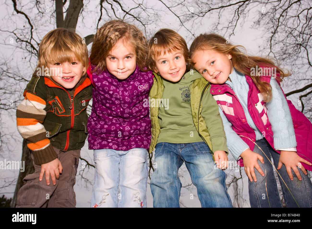 A group of young children of ages 4, 4, 3 and 4, outdoors Stock Photo