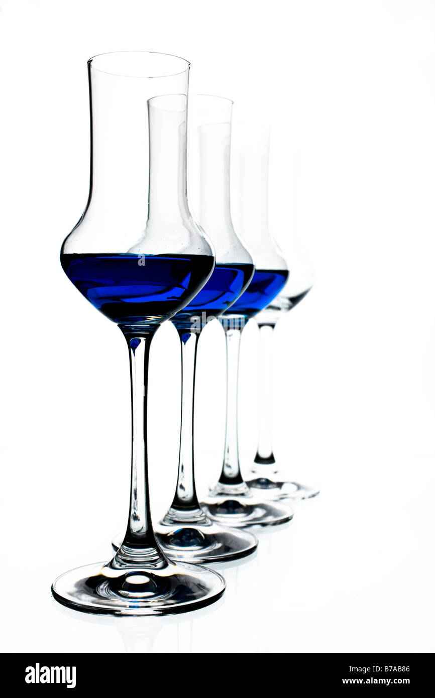 Blue liqueur in row of glasses Stock Photo