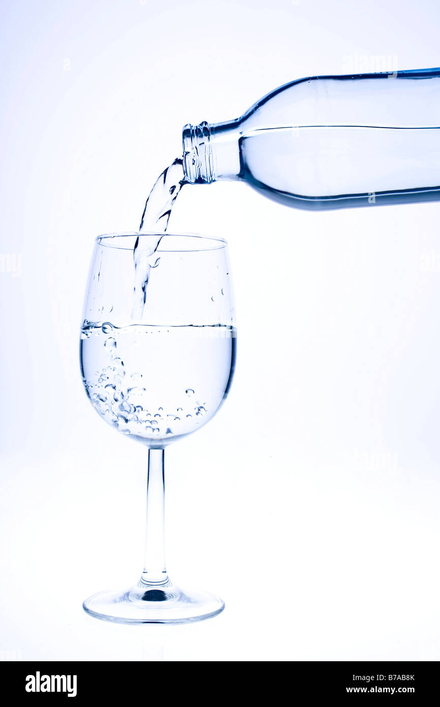Pouring fresh water into a glass Stock Photo