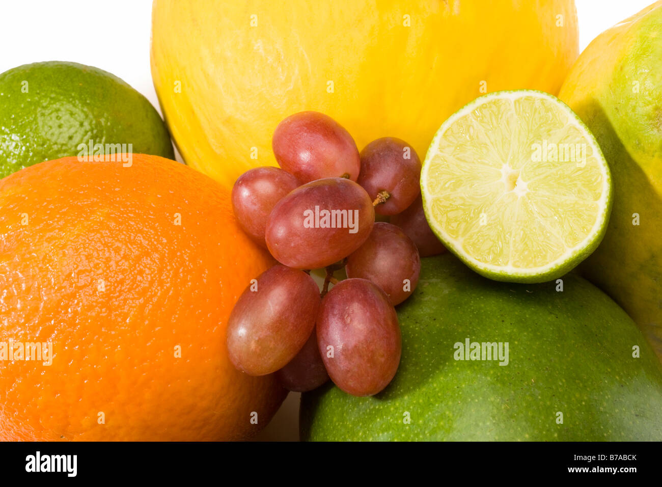 Exotic fruit, melon, mango, orange, grapes, half a lime Stock Photo Alamy