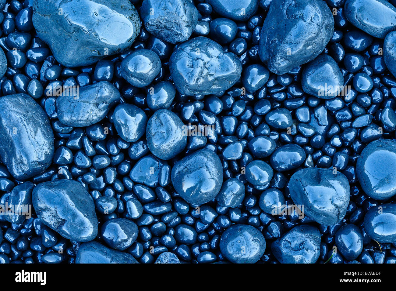 Lava pebbles polished smooth by the surf, stones on the beach in the