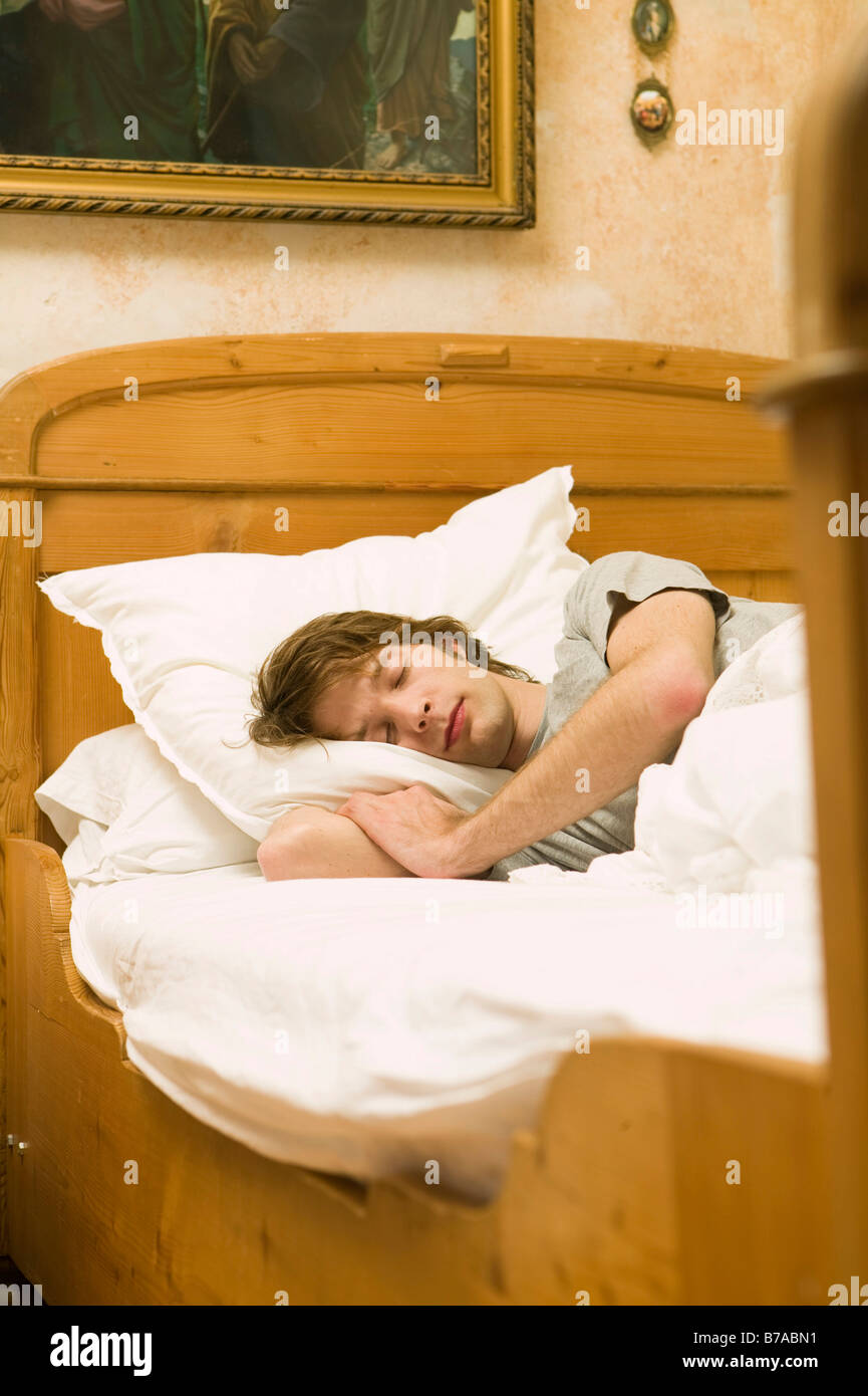 Young man in bed, Germany Stock Photo Alamy