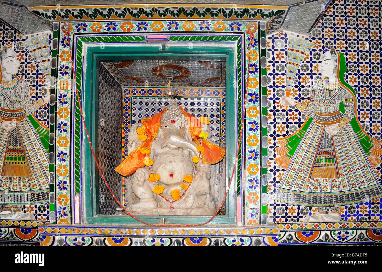 Shrine to Ganesh in the form of a small tiled niche with a statue of Ganesh inside. Stock Photo