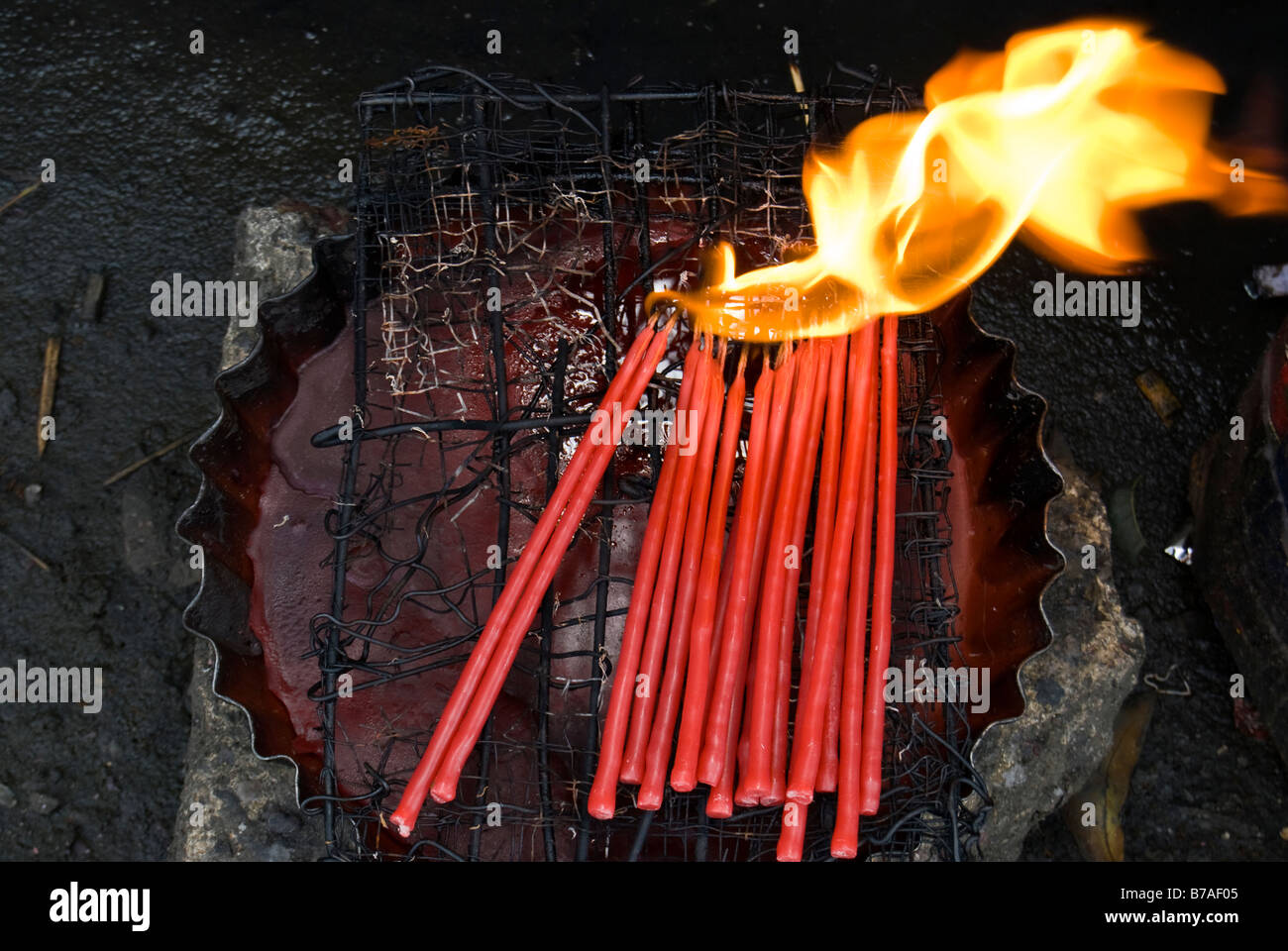 Votive candles burning over a container of wax, Cebu Cathedral