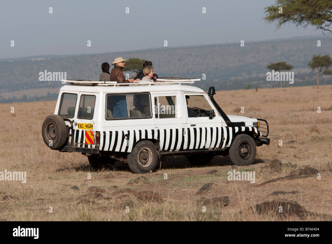 Tourists game viewing from vehicles Masai Mara North Reserve Kenya Stock Photo