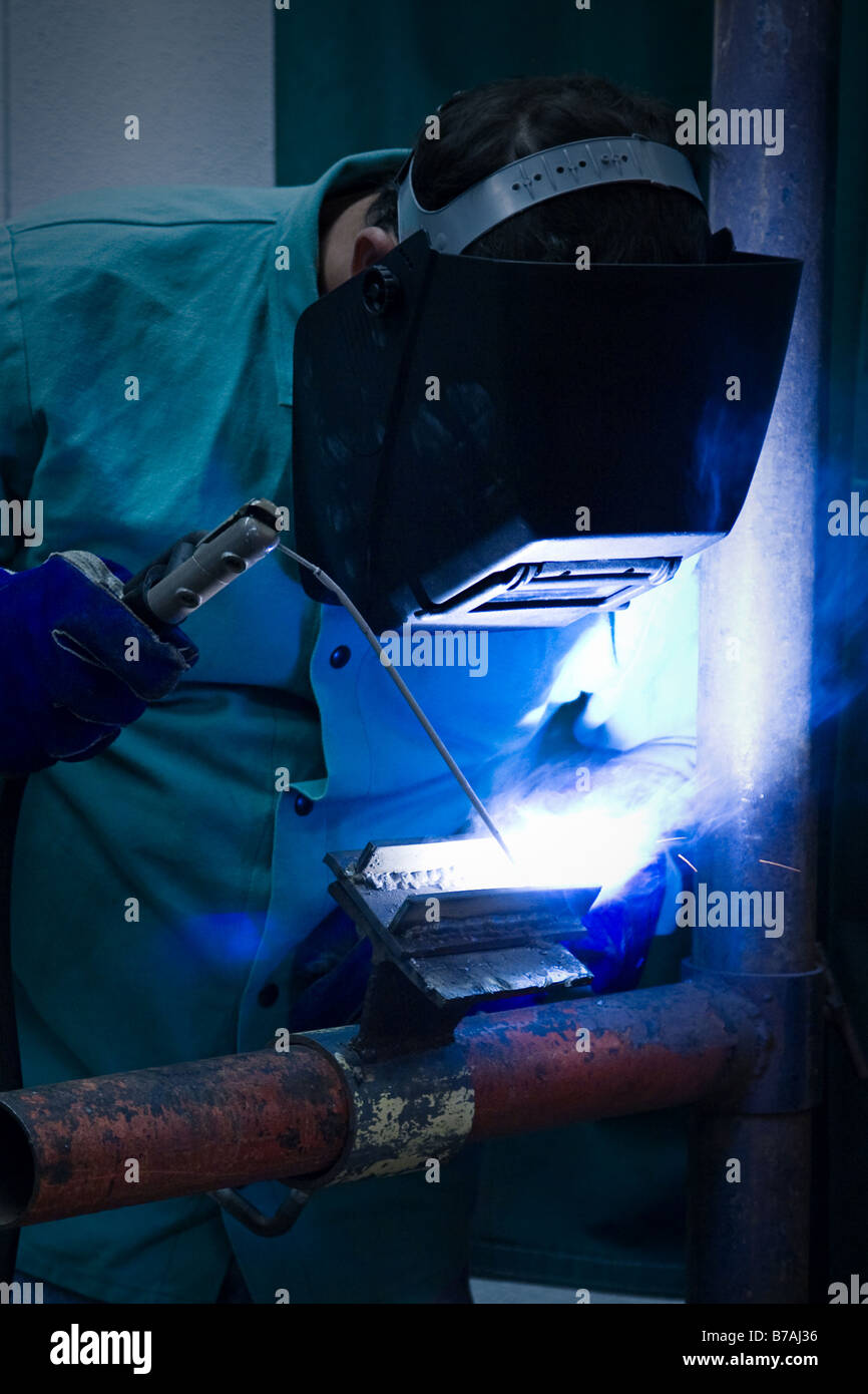 Welder working in the blue light of his torch Stock Photo Alamy
