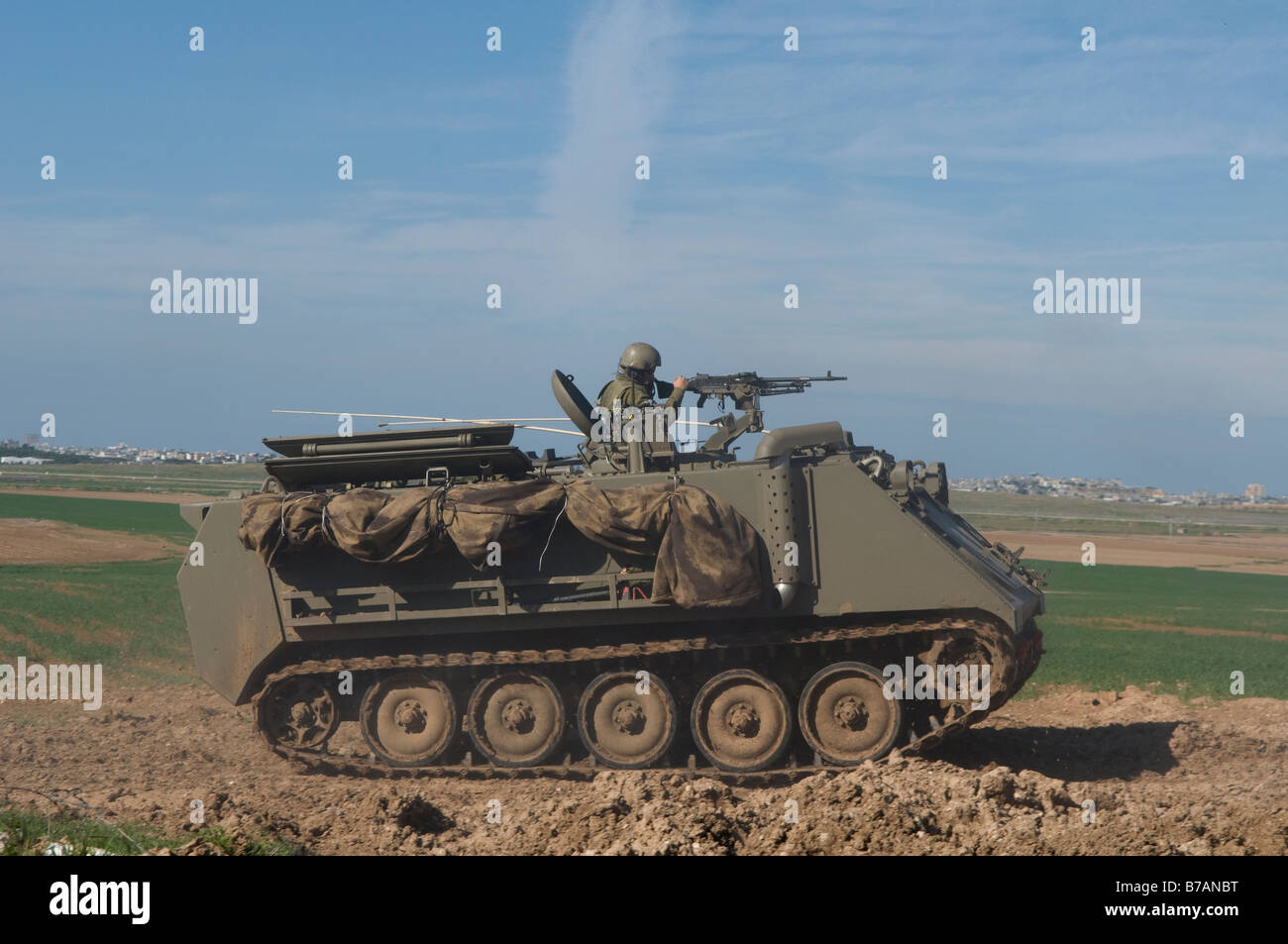 An IDF armored personnel carrier maneuvering at the Israel-Gaza border, Israel Stock Photo