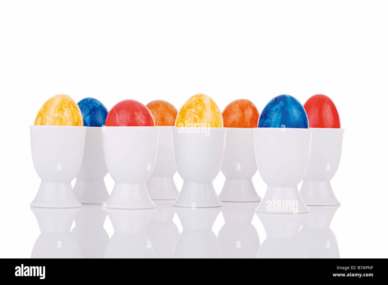 Colourful easter eggs in eggcups Stock Photo