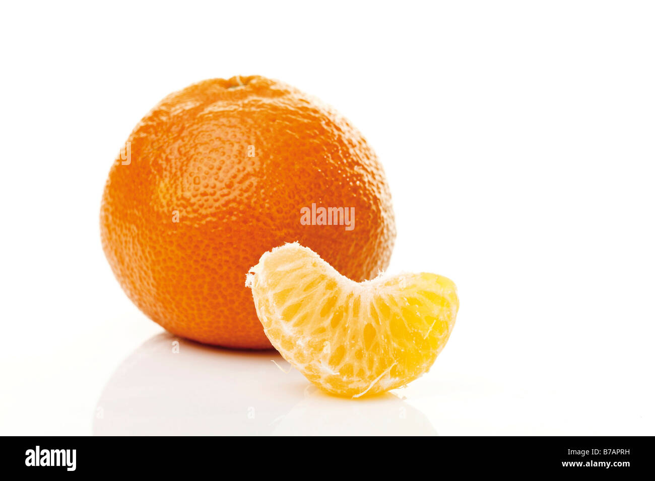 Mandarine with a peeled piece Stock Photo