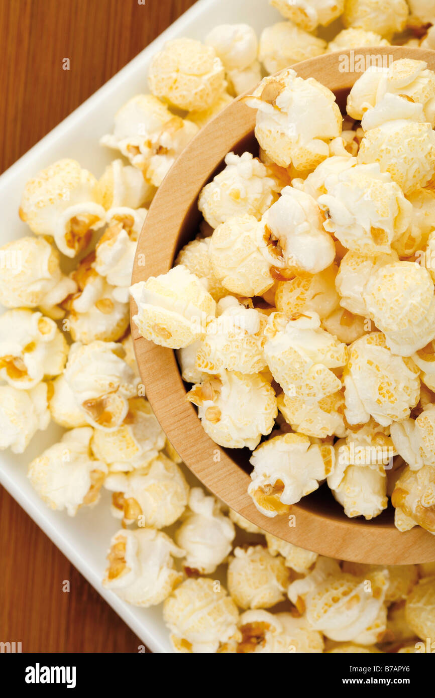 Popcorn in a wooden dish on a wooden table Stock Photo