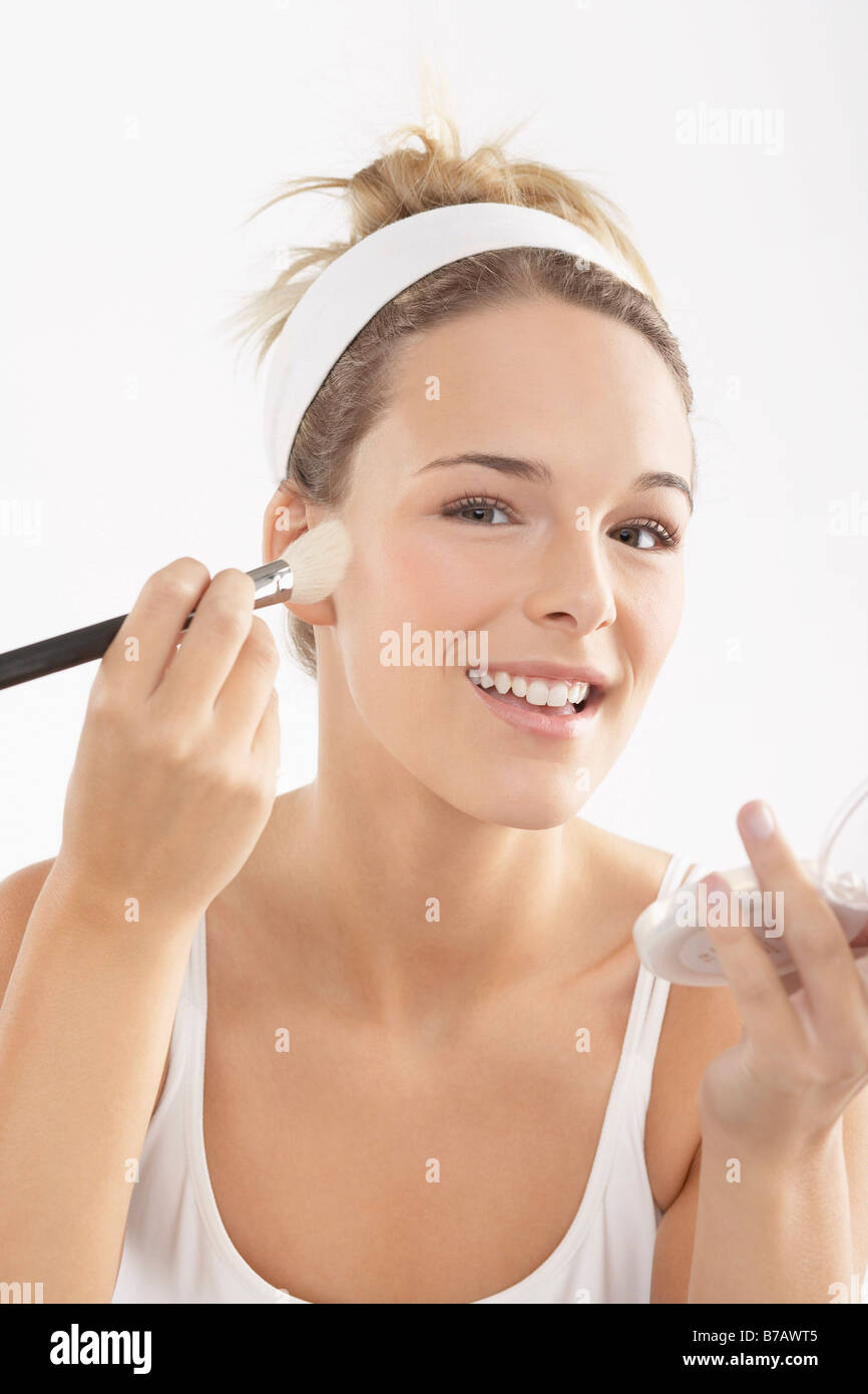 Young Woman Applying Make-Up Stock Photo