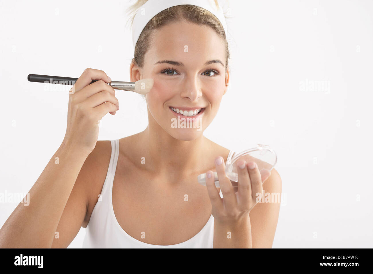 Young Woman Applying Make-Up Stock Photo